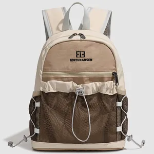 Détail d'un sac à dos élégant avec poche en maille à cordon en beige et marron
