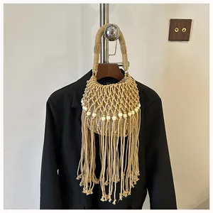 Detailed view of handmade woven bucket bag with long tassels and wooden beads