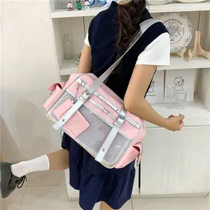Model wearing a pink Japanese style Ita bag featuring silver straps and a clear display window