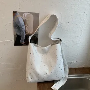 Minimalist canvas tote bag with shiny silver star sequins and wide strap