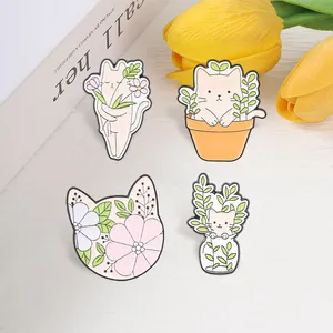 Collection of four cartoon cat enamel pins with floral and plant themes