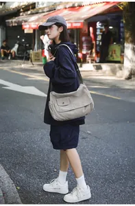 Large canvas messenger bag shown on street with casual urban style