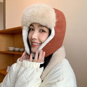 Stylish orange winter trapper hat with white plush fur trim for women's outdoor warmth