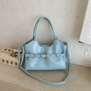 Elegant light blue women's tote bag featuring unique decorative belt buckle detail design