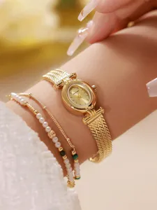 Primer plano de un elegante reloj de mujer con espigas de oro en la muñeca con joyas