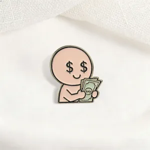 Close-up detail of a funny cartoon character enamel pin holding a stack of money