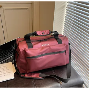 Spacious burgundy travel duffel bag with adjustable shoulder strap for gym hiking