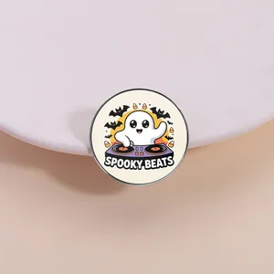 Detailed close-up of a cute ghost DJ enamel pin featuring Spooky Beats text and bats