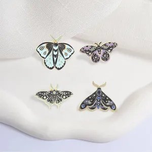 Set of vintage mystical moth and butterfly enamel pins with celestial moon and star motifs
