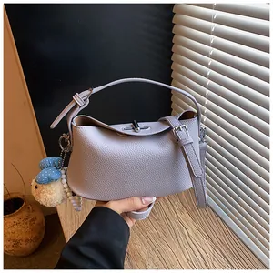 Light purple textured leather bucket bag with cute plush bunny charm