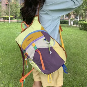 Rear view of a stylish dopamine-colored large capacity hiking backpack worn in a park