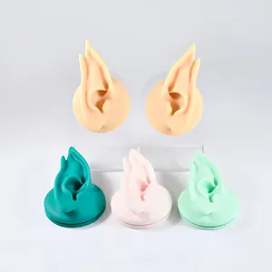 Detailed view of silicone elf ear models in multiple colors for earring display.
