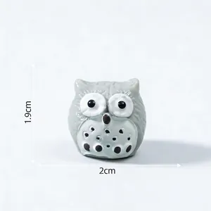 Detailed view of miniature resin owl figurine showing 1.9cm height and 2cm width dimensions