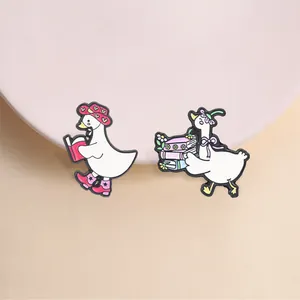 Gedetailleerde weergave van schattige witte gans emaille spelden met leesthema's