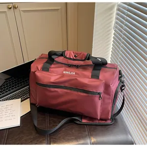 Large maroon waterproof travel duffel bag with NINGJIA logo for fitness and hiking trips