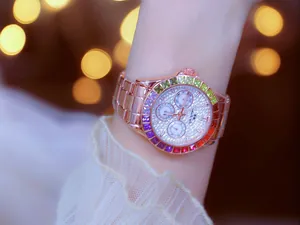 Close-up detail of a premium rose gold women's watch with a rainbow gradient crystal bezel.