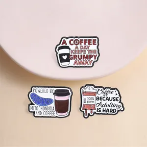 Detail view of humorous coffee-themed enamel pins with Adulting is Hard slogan text.