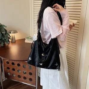 Chic black large capacity tote bag with silver butterfly charms and rabbit accessory