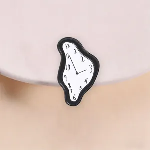 Detalle de un broche de reloj derretido inspirado en Dalí sobre un fondo rosa suave