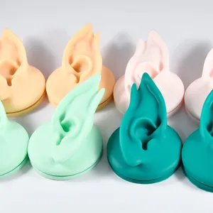 Professional multi-color silicone elf ear models for jewelry display and piercing practice.