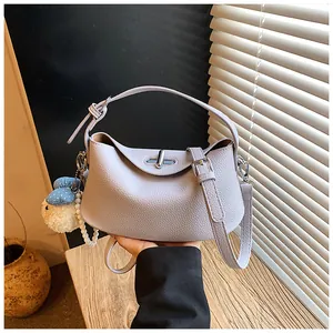 Lavender pebbled leather bucket bag with twist-lock and cute decorative pearl charm