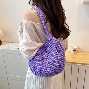 Detailed close-up showing the intricate texture of this purple hand-knitted crochet bag