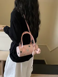 Fashionable pink cylindrical canvas handbag for women featuring cute animal patterns