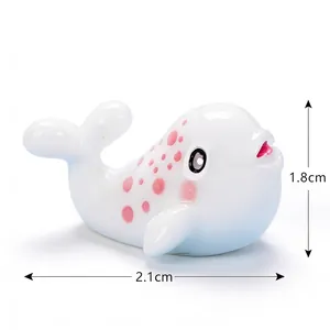 Close-up of miniature resin beluga whale with pink spots for micro landscape decor