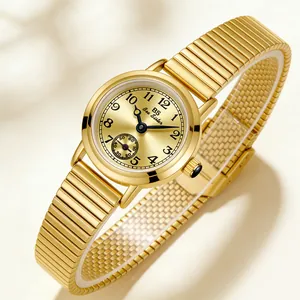 Detailed view of the vintage gold women's watch with bamboo expansion band and small second dial
