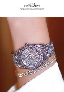 Detail shot of a luxury silver iced-out watch with sparkling rhinestones on the wrist.