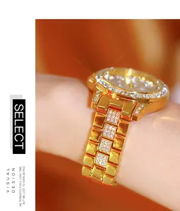 Close-up of luxury gold women's watch with full crystal pavé setting