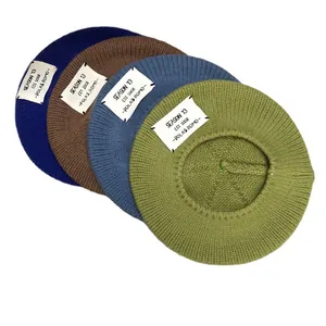 Set of knitted beret hats in four colors with stylish letter patches for autumn
