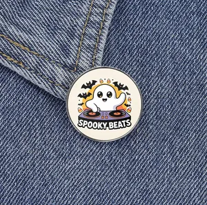 Detailed macro view of the Spooky Beats DJ ghost metal enamel pin on a denim jacket
