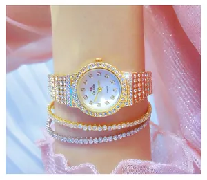 Primer plano de un reloj de diamantes de imitación dorados con pulseras brillantes