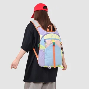 Detailed back view of a vibrant multicolored patchwork travel backpack on a model