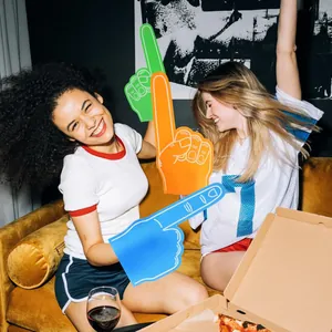 Cheerful women celebrating with colorful giant EVA foam fingers for sports event cheering