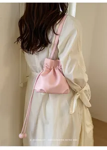 Detail shot of a pink drawstring cloud bag with a minimalist retro vibe for women