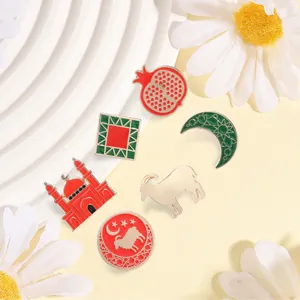Macro detail view of colorful ethnic metal pins featuring mosque, moon, and sheep motifs
