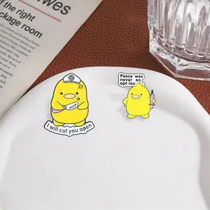 Close-up of funny nurse yellow duck enamel pins with humorous quotes on white tray.