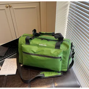 Large green gym duffel bag with front zipper pocket and adjustable shoulder strap