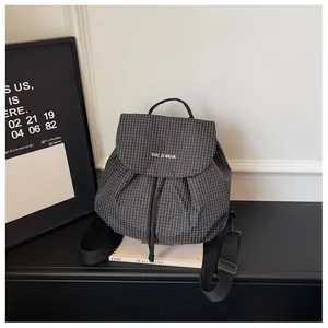 Detailed view of a stylish black and white checkered small casual backpack for women