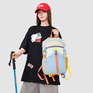 Asian model holding a vibrant multi-color dopamine style outdoor hiking backpack