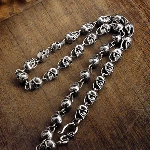 Macro view of vintage silver-plated skull chain links with oxidized finish for men