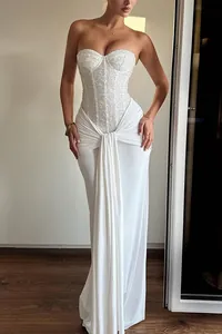 Elegant white strapless corset maxi dress with sequined bodice and draped waist detail