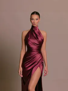 Elegant burgundy satin halter neck evening dress with high slit and pleated bodice.