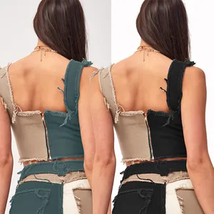 Detailed back view of women's patchwork denim crop top with frayed edges and zipper closure