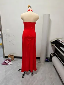 Detailed back view of an elegant red halter neck bodycon maxi dress on a studio mannequin