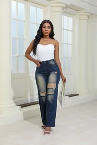 Full length view of stylish women's high waisted washed denim jeans with ripped detail