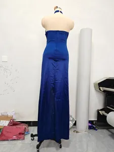 Detailed back view of a royal blue halter neck slim fit evening maxi dress on mannequin.