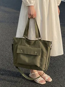 Large olive green canvas tote bag with front pocket and adjustable shoulder strap